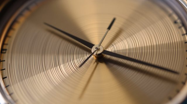 Extreme Close-Up example: extreme close-up of a watch face, the second hand and brushed metal filling the frame