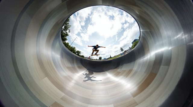 Fisheye example: a skateboarder in a bowl, the whole frame bulging, the horizon curved