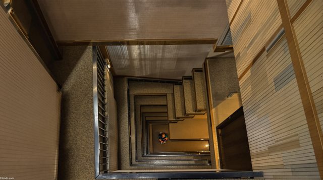 High Angle example: looking down a stairwell at a child sitting alone on the steps