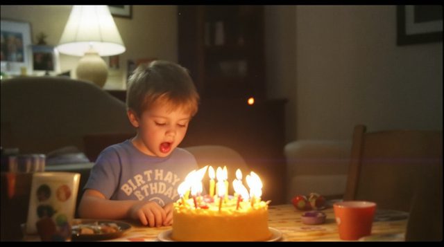 VHS Camcorder example: a birthday party in a living room, a kid blowing out candles